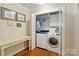 The laundry closet shows a white washer and dryer, a folding desk, and framed wall art at 4960 York Hwy, Rock Hill, SC 29732