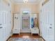 The home's mudroom features two white cabinets for storage, a window, and dark hardwood floors at 4960 York Hwy, Rock Hill, SC 29732