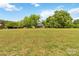 Picturesque home nestled on a sprawling lawn with mature trees offering privacy and charm at 4960 York Hwy, Rock Hill, SC 29732