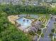 Community clubhouse with swimming pool, tennis courts, playground, and parking areas amid lush trees at 509 Silers Bald Dr, Fort Mill, SC 29715