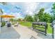A backyard features a patio, lounge furniture under a yellow umbrella, a grill, and a lawn at 509 Silers Bald Dr, Fort Mill, SC 29715