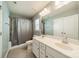 Well-lit bathroom featuring a double sink vanity, shower, and neutral tile floor at 509 Silers Bald Dr, Fort Mill, SC 29715