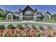 Beautiful clubhouse exterior with stone accents, large windows, and manicured landscaping at 509 Silers Bald Dr, Fort Mill, SC 29715