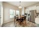 Cozy dining area with wood floors, a dining table set for four, and natural light from the windows at 509 Silers Bald Dr, Fort Mill, SC 29715