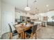 A dining area with wood floors, a dining table set for four, and an adjacent modern kitchen at 509 Silers Bald Dr, Fort Mill, SC 29715