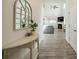 Inviting entryway with stylish console table, decorative mirror, and views into a spacious living room at 509 Silers Bald Dr, Fort Mill, SC 29715