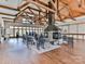 An interior features a stone fireplace, high, exposed beam ceilings, wood floors, and seating at 509 Silers Bald Dr, Fort Mill, SC 29715