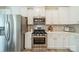 Modern kitchen featuring stainless steel appliances, white cabinets, and a subway tile backsplash at 509 Silers Bald Dr, Fort Mill, SC 29715