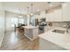 Modern kitchen with white cabinetry, stainless steel appliances, center island, and adjacent dining area at 509 Silers Bald Dr, Fort Mill, SC 29715