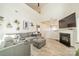 Bright, open living space with a gray sectional sofa, fireplace, TV, and view to the kitchen at 509 Silers Bald Dr, Fort Mill, SC 29715