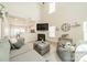 Comfortable living room features a gray sofa, fireplace, large TV, and a view to the kitchen at 509 Silers Bald Dr, Fort Mill, SC 29715