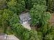 Aerial view of a charming two-story home with a three-car garage nestled in a lush, green, wooded area at 5308 Lambert Ct, Waxhaw, NC 28173