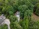 Aerial shot of a house surrounded by lush greenery, showcasing its serene setting at 5308 Lambert Ct, Waxhaw, NC 28173