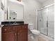 Neat bathroom with a granite vanity, framed mirror, and glass enclosed shower at 5308 Lambert Ct, Waxhaw, NC 28173