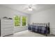 Bright bedroom featuring a comfortable bed, natural light, and complemented by a white dresser and nightstand at 5308 Lambert Ct, Waxhaw, NC 28173