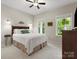 Cozy bedroom with plush carpet, natural light from two windows, and a ceiling fan for added comfort at 5308 Lambert Ct, Waxhaw, NC 28173