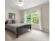 Comfortable bedroom with a large window view and natural light, decorated with neutral tones for a serene ambiance at 5308 Lambert Ct, Waxhaw, NC 28173