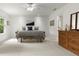 Well-lit bedroom featuring a cozy bed with stylish accents, complemented by a wooden dresser and ample natural light at 5308 Lambert Ct, Waxhaw, NC 28173