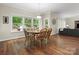 Inviting breakfast area filled with natural light, featuring hardwood floors and seamless flow to living area at 5308 Lambert Ct, Waxhaw, NC 28173
