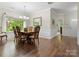 Elegant dining room featuring hardwood floors, decorative molding, and a large window with backyard view at 5308 Lambert Ct, Waxhaw, NC 28173