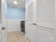 Functional laundry room with modern appliances, tiled floor, and organized storage, offering practicality and convenience at 5308 Lambert Ct, Waxhaw, NC 28173