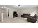Spacious upper living room area furnished with a comfy leather sofa, and a sleek entertainment center at 5308 Lambert Ct, Waxhaw, NC 28173