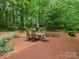 Spacious brick patio featuring an outdoor dining set and a charming waterfall feature at 5308 Lambert Ct, Waxhaw, NC 28173