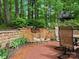 Close-up of a stone patio with a beautiful waterfall and a tranquil setting at 5308 Lambert Ct, Waxhaw, NC 28173