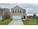 Charming two-story home featuring a two-car garage, black shutters and a well-maintained lawn at 581 E Sparkleberry St, Chester, SC 29706