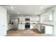 Bright kitchen with stainless steel appliances, granite countertops, and white cabinets at 581 E Sparkleberry St, Chester, SC 29706