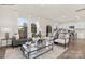 Open-concept living room featuring a gray sofa, bright white walls, and access to a modern kitchen at 581 E Sparkleberry St, Chester, SC 29706