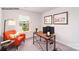 Bright home office space with a large window, modern desk, and comfortable orange chair at 581 E Sparkleberry St, Chester, SC 29706