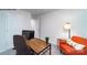 This office space has a rustic desk, comfortable orange chair, and neutral colors at 581 E Sparkleberry St, Chester, SC 29706