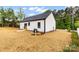 Side and rear exterior view showcasing a new air conditioner, fencing, and newly installed sod at 605 Stirewalt Rd, China Grove, NC 28023