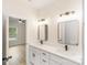 Well-lit bathroom features double sinks with black fixtures and vanity mirrors adjacent to a doorway at 605 Stirewalt Rd, China Grove, NC 28023
