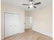 Light-filled bedroom features wood floors, a ceiling fan, and a convenient double-door closet at 605 Stirewalt Rd, China Grove, NC 28023