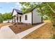 Stylish single-story home showcasing a sidewalk, black accents, and white siding at 605 Stirewalt Rd, China Grove, NC 28023