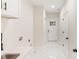 Hallway with white marble floors, white doors and walls, with a small sink and counter at 605 Stirewalt Rd, China Grove, NC 28023