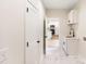 Hallway with a view to a kitchen and small sink, plus white doors, walls, and marble flooring at 605 Stirewalt Rd, China Grove, NC 28023