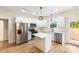 Bright kitchen features stainless steel appliances, white cabinetry, and an island with a white countertop at 605 Stirewalt Rd, China Grove, NC 28023