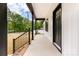 A covered front porch features black railings and plenty of space to sit and relax at 605 Stirewalt Rd, China Grove, NC 28023