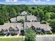 Bird's eye view of townhomes in community featuring well-manicured lawns and mature trees at 614 Stone Village Dr, Fort Mill, SC 29708