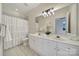 Bright bathroom with double sinks, tile floors, large mirror, and shower with curtain at 614 Stone Village Dr, Fort Mill, SC 29708