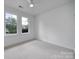Empty bedroom with two windows and neutral carpet at 614 Stone Village Dr, Fort Mill, SC 29708
