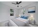 Bright staged bedroom with ceiling fan, two windows, and neutral decor at 614 Stone Village Dr, Fort Mill, SC 29708
