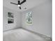 Bedroom with two windows, neutral carpet, and ceiling fan at 614 Stone Village Dr, Fort Mill, SC 29708