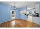 Open dining area next to the kitchen has white cabinets and door to the yard at 614 Stone Village Dr, Fort Mill, SC 29708