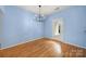 Bright dining room has modern chandelier and wood floors at 614 Stone Village Dr, Fort Mill, SC 29708