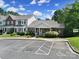View of townhome with covered porch, lush landscaping and reserved parking spaces at 614 Stone Village Dr, Fort Mill, SC 29708