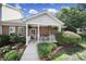 Charming townhome with covered porch, lush landscaping and walkway to entrance at 614 Stone Village Dr, Fort Mill, SC 29708
